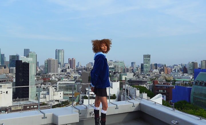 Image of a model with a cityscape in the background, shot on the ZV-1 II